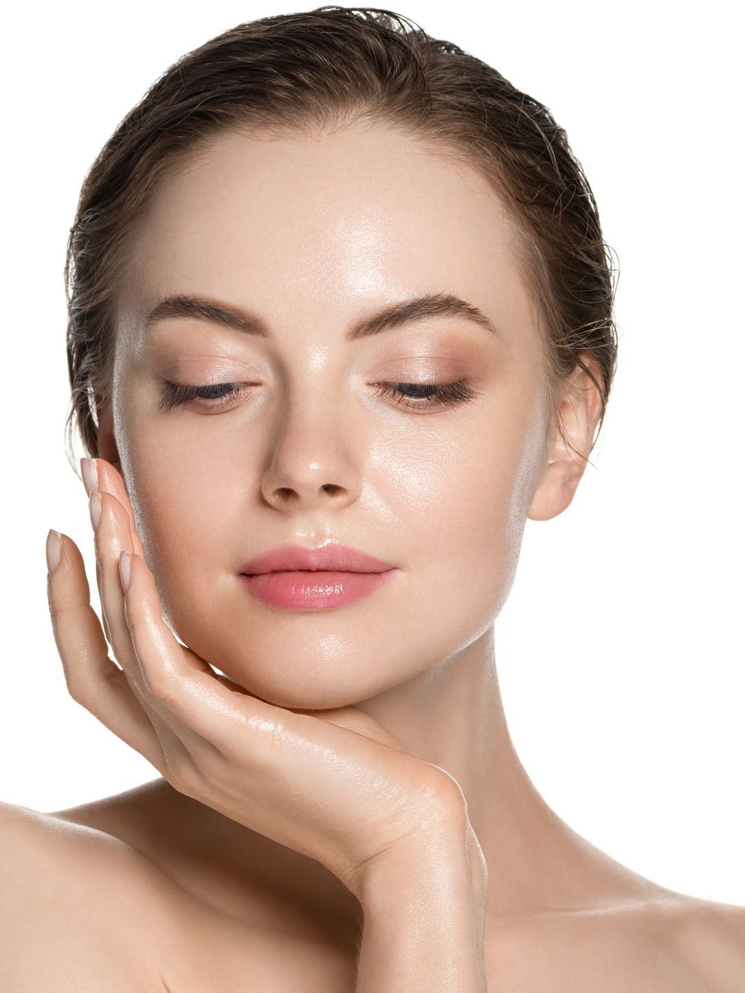 A close up of a woman 's face with her hand on her chin.