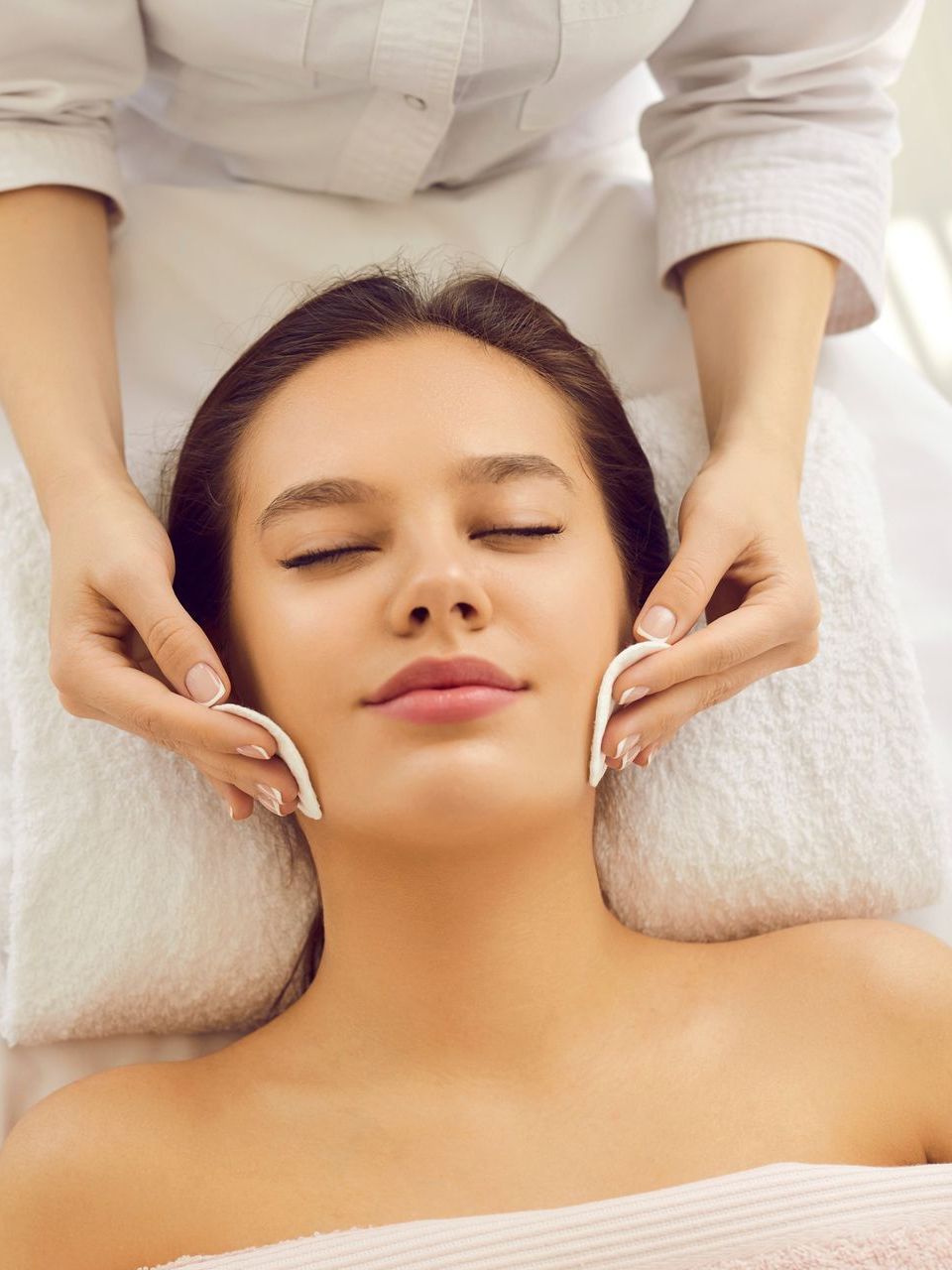 A woman is getting a facial treatment at a spa.