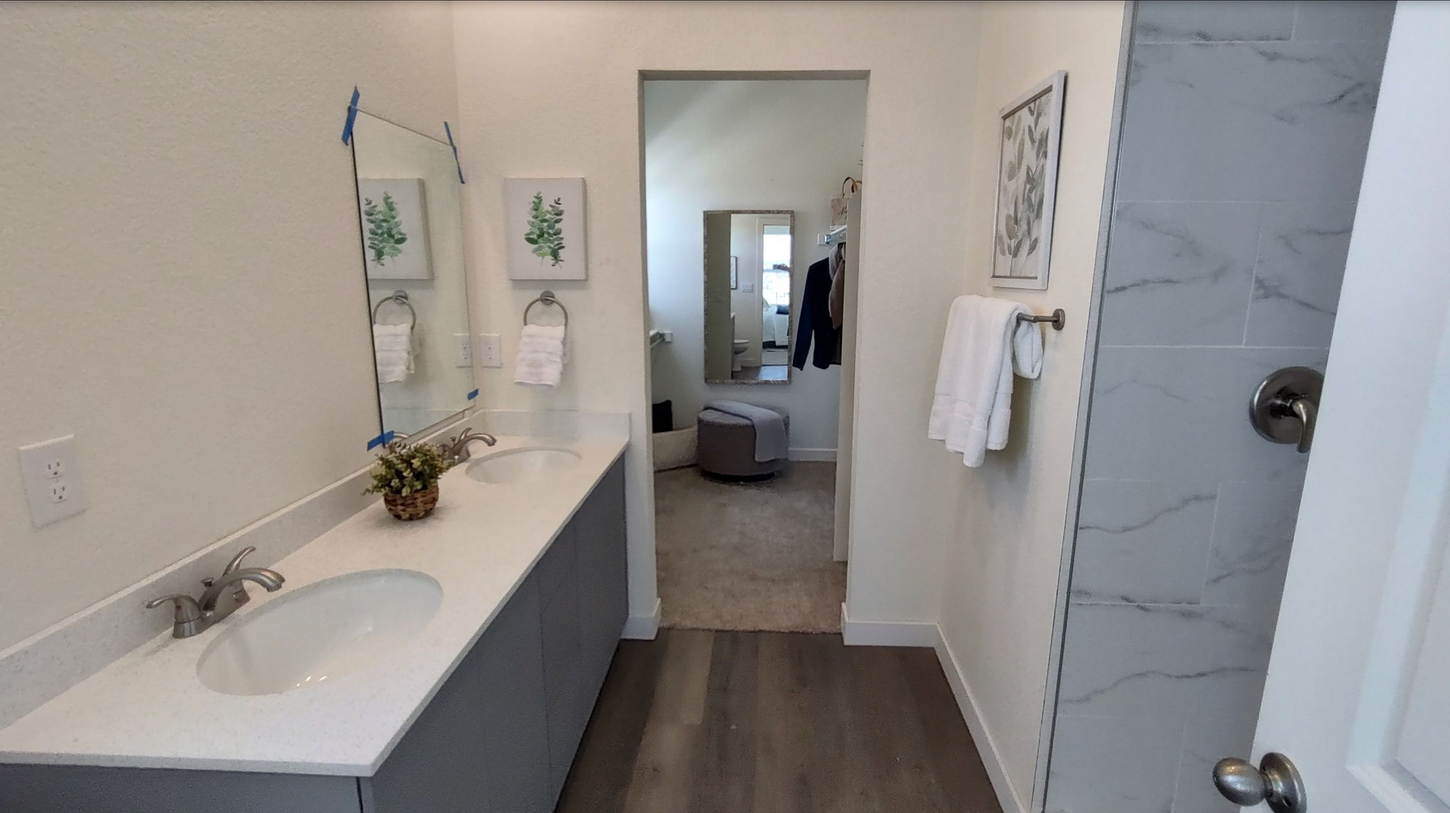 A bathroom with two sinks and a mirror.