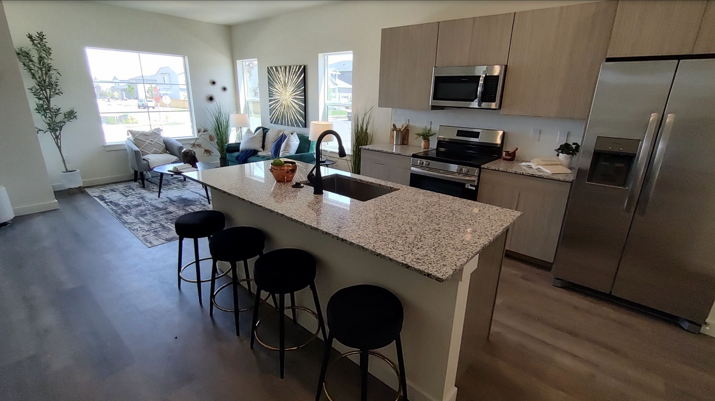 A kitchen with granite counter tops and stainless steel appliances