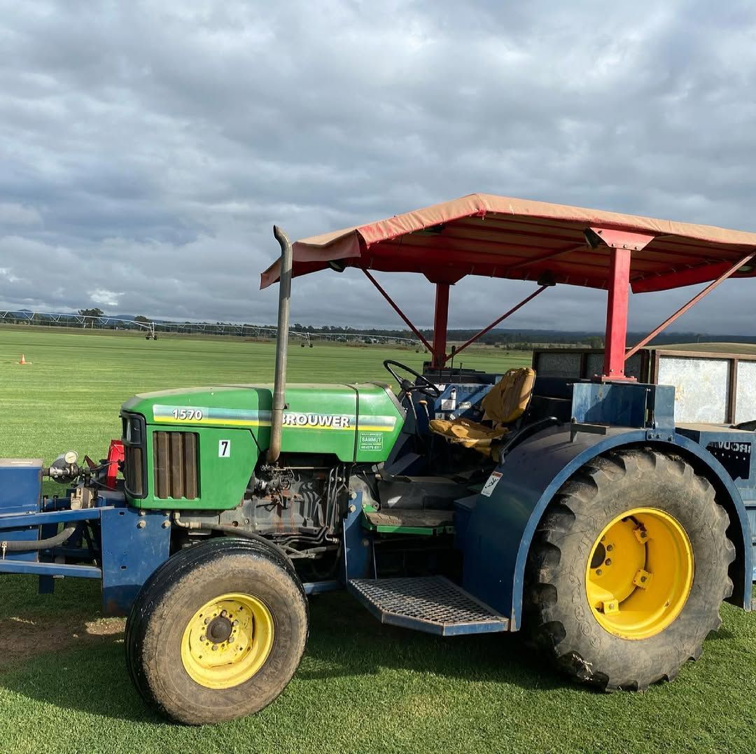 Green John Deere Tractor With Blue Accents and Red Canopy — Placid Hills Turf in Toowoomba City, QLD