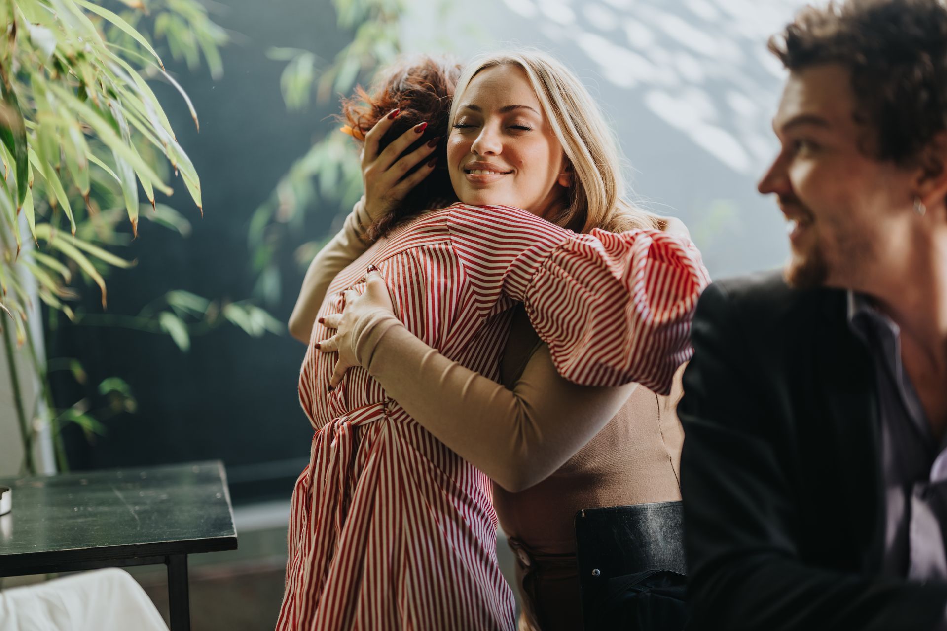 Two friends share a heartfelt hug. Two friends share a heartfelt hug.