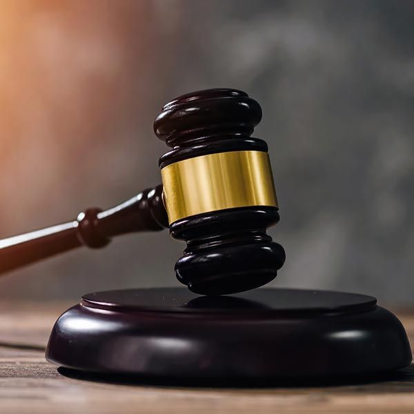 Wooden judge gavel on a desk representing law justice and expert bail bonds services. Wooden judge gavel on a desk representing law justice and expert bail bonds services.