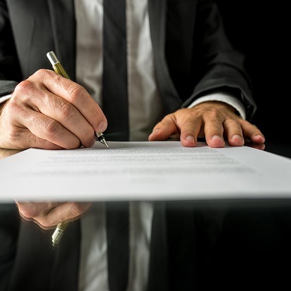 Professional signing legal documents for bail bonds services to ensure a quick release. Professional signing legal documents for bail bonds services to ensure a quick release.
