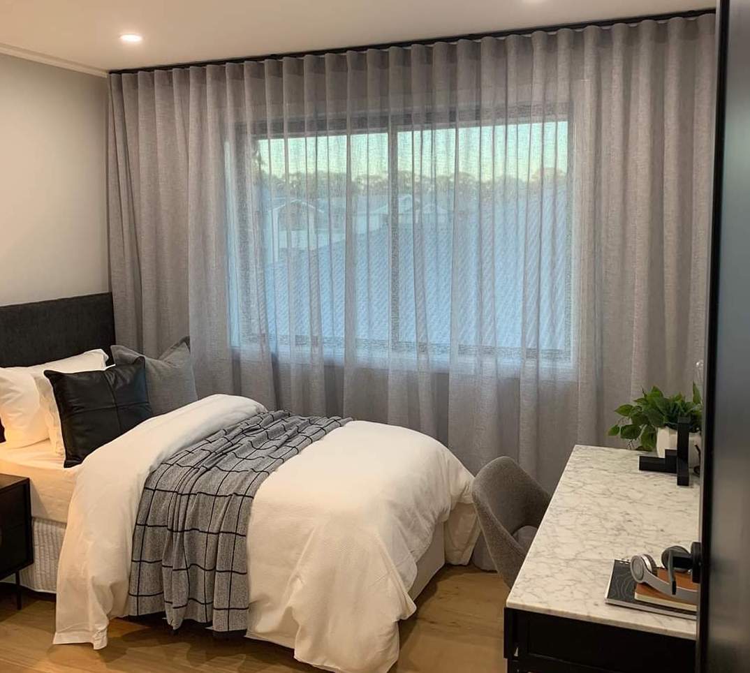 A Bedroom With a Bed , Desk , and Window — Abode Shutters & Blinds In Taree South, NSW