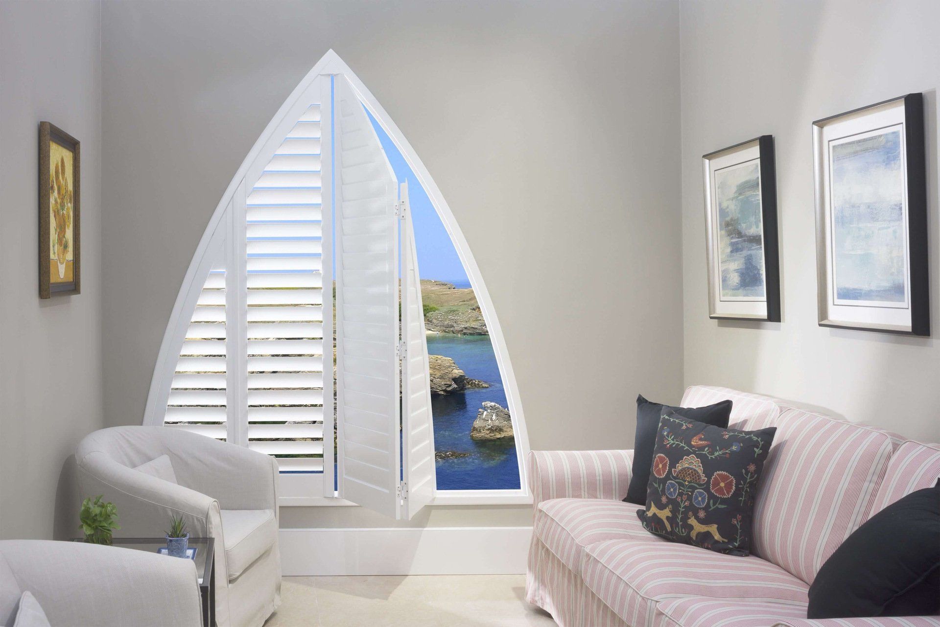A Living Room With a Boat Shaped Window and a Couch — Abode Shutters & Blinds In Taree South, NSW