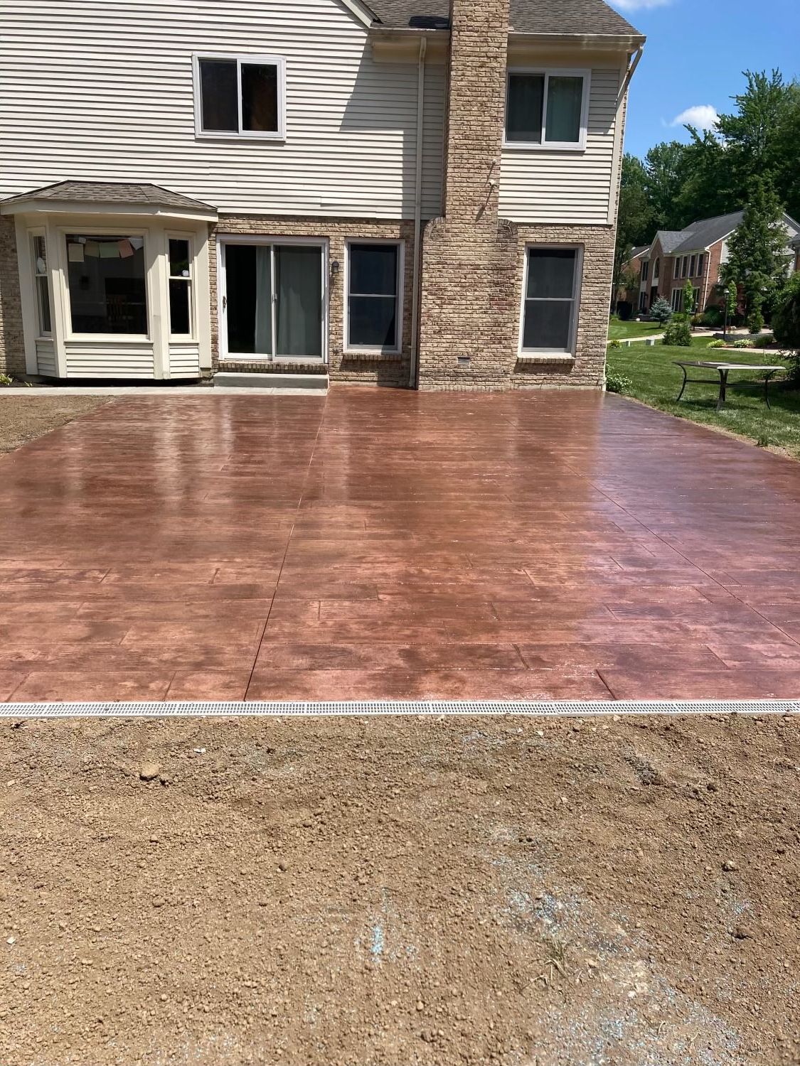 There is a concrete driveway in front of a house.