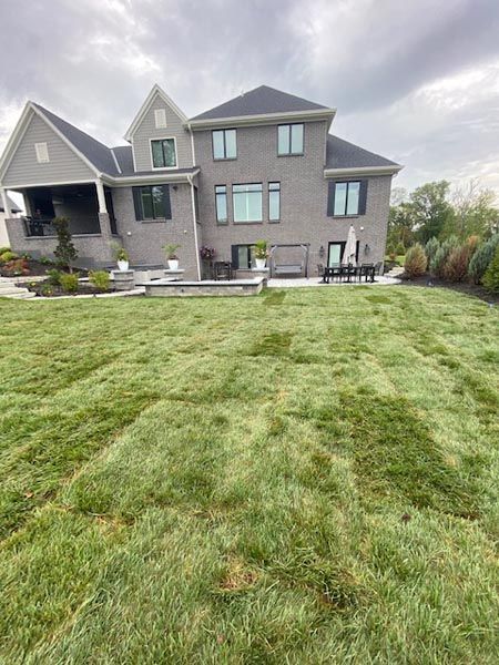 A large house with a large lawn in front of it.