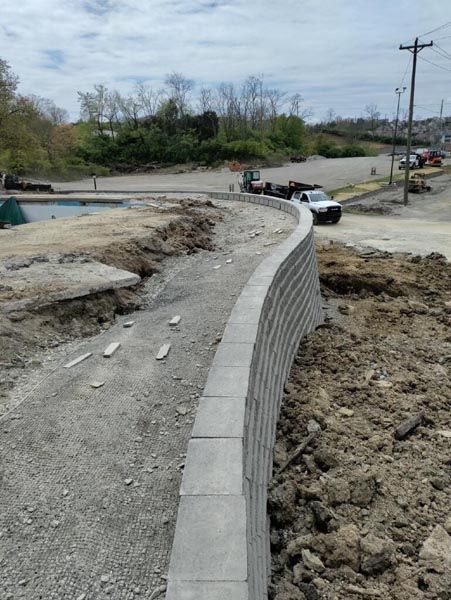 A concrete wall is being built on the side of a road