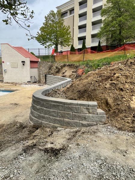 A brick wall is being built in front of a building