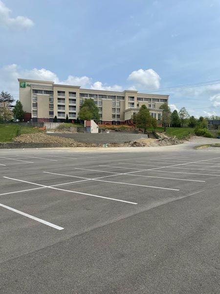 A parking lot with a large building in the background
