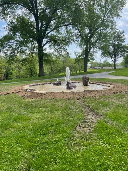 A fountain is being built in the middle of a park.