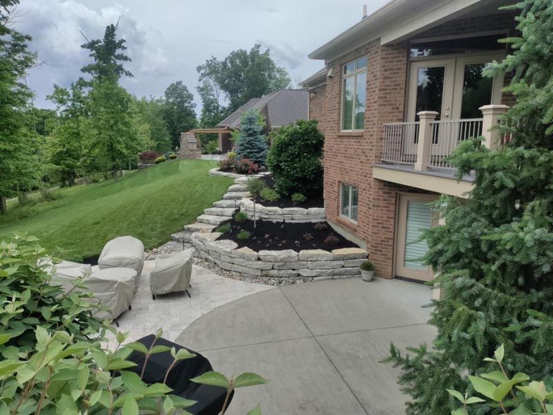 A large brick house with a patio in front of it