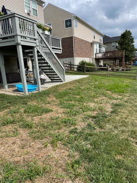 A house with a deck and stairs in the backyard.