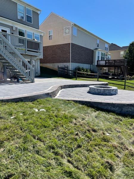 There is a fire pit in the backyard of a house.