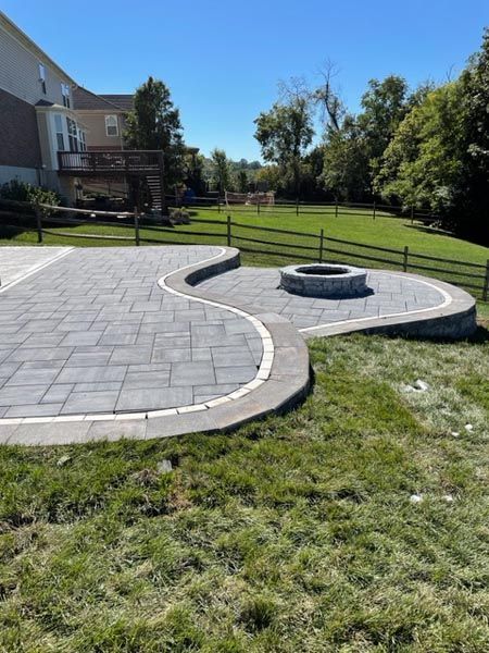 There is a fire pit in the middle of the patio.