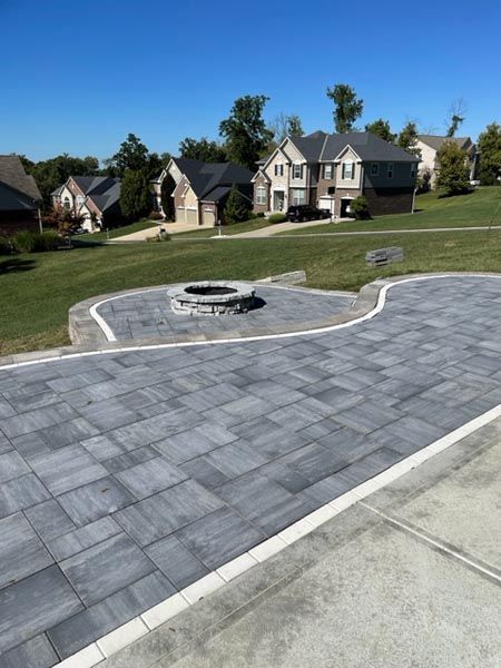 A driveway with a fire pit in the middle of it