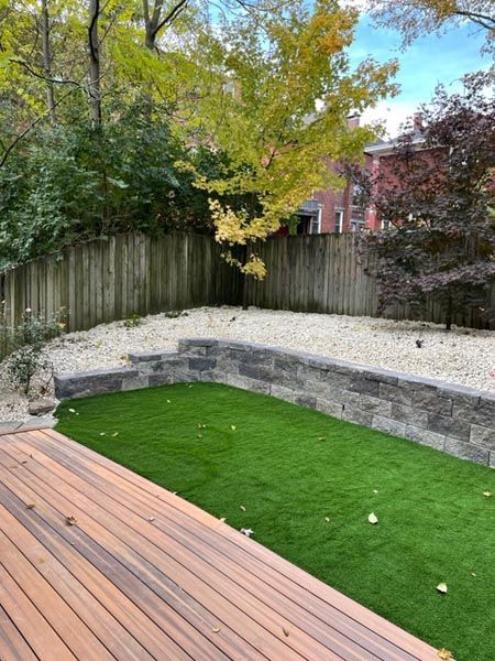 A backyard with a wooden deck and a grassy area.