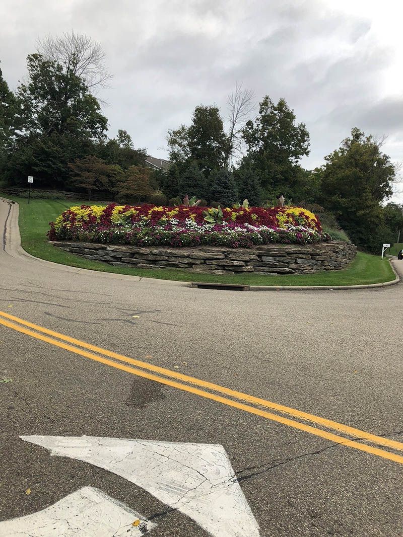 There is a flower bed in the middle of the road.