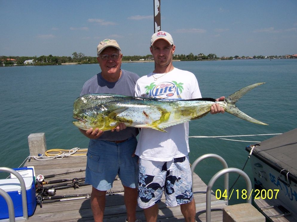 Two men holding a large fish on a dock in 2007