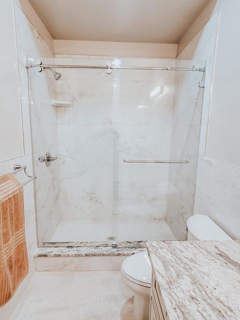 A Bathroom with a Sliding Glass Shower Door | Clayton, NC | Clayton Glass & Mirror