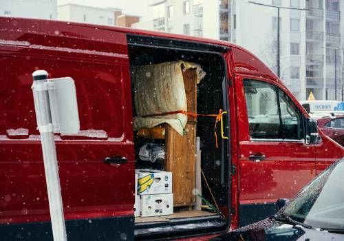 A red Van delivering packages
