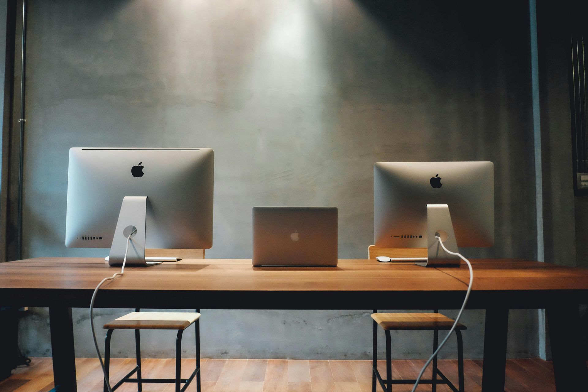A desk with Electronics and Computers in an office. 