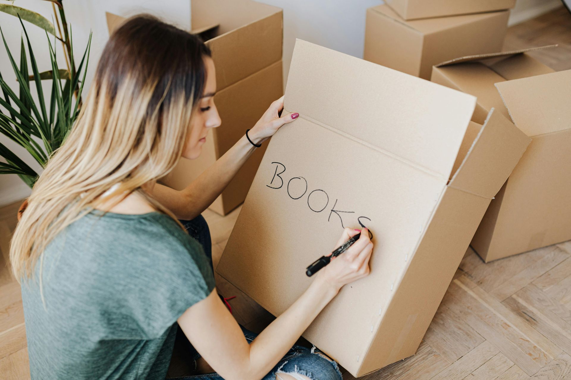 A woman decluttering her home from boxes and stuff.
