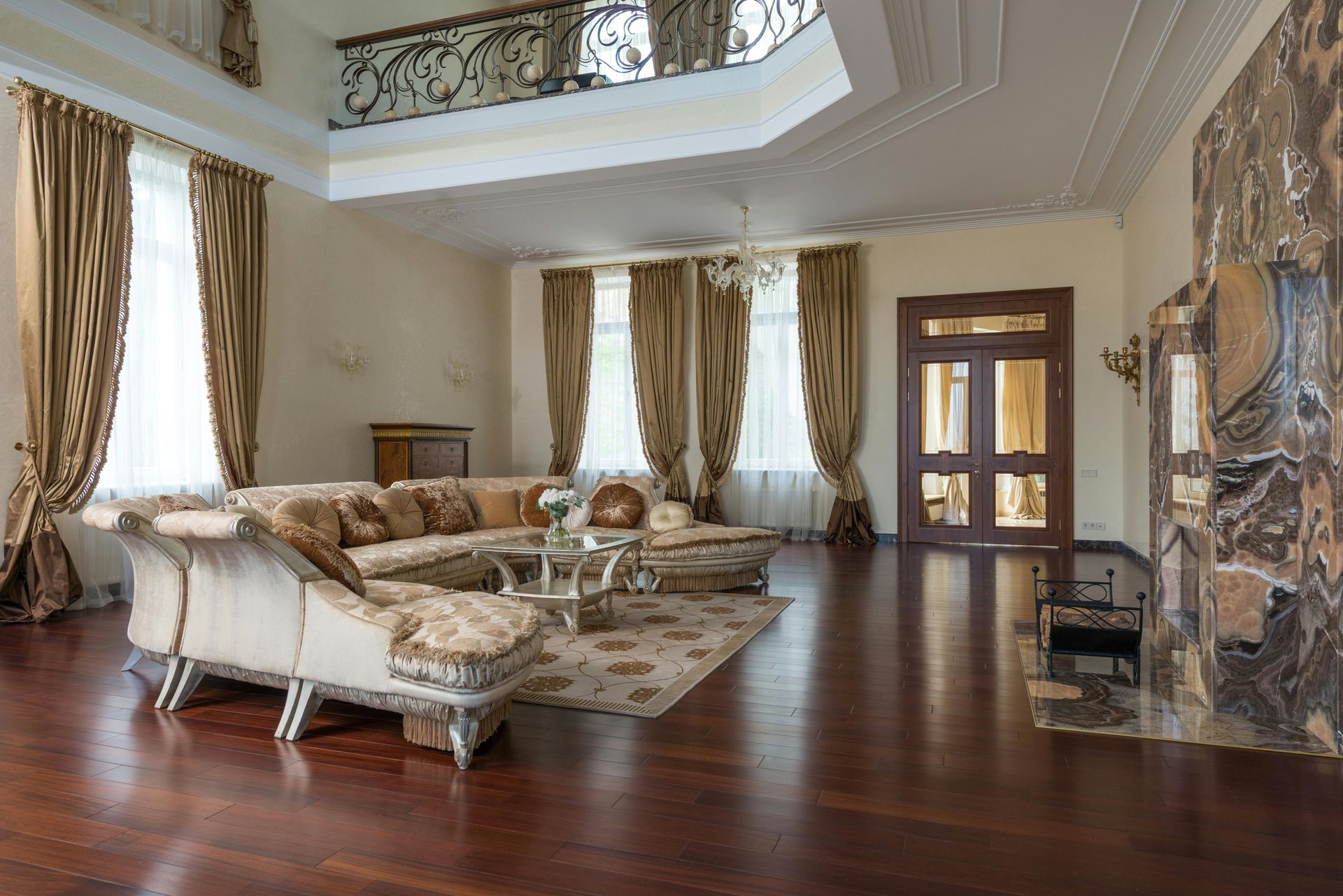 A living room with a large white sofa on the middle.
