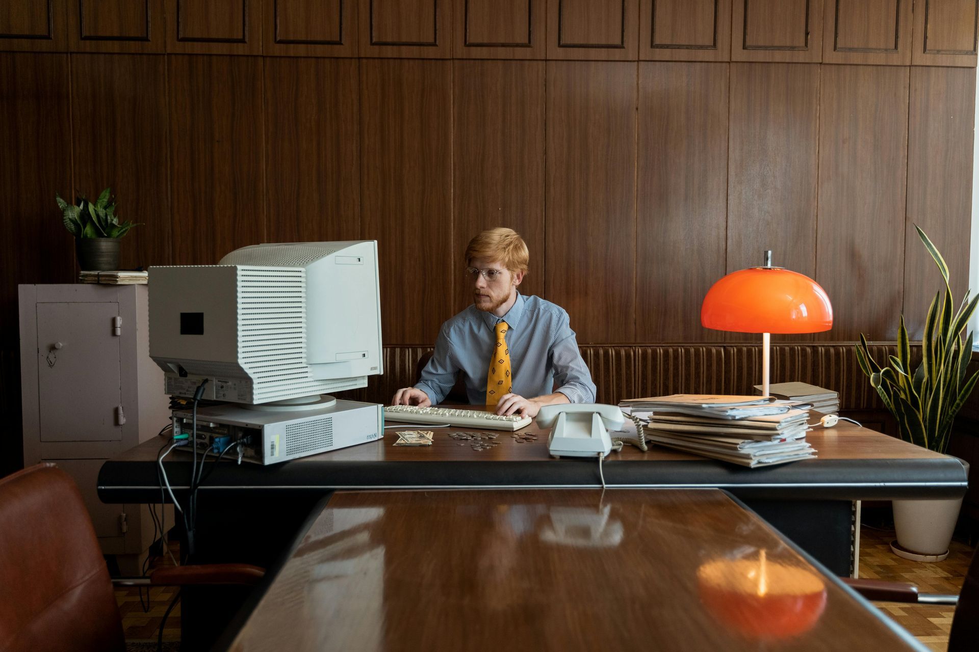 An image of an office with dual monitor screens showered by afternoon glow.