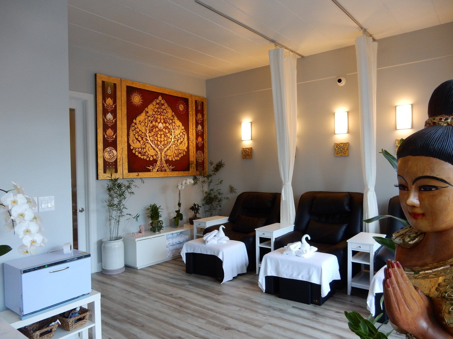 statue of traditional Thai woman in seating area