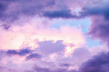 A sunset with purple and pink clouds in the sky