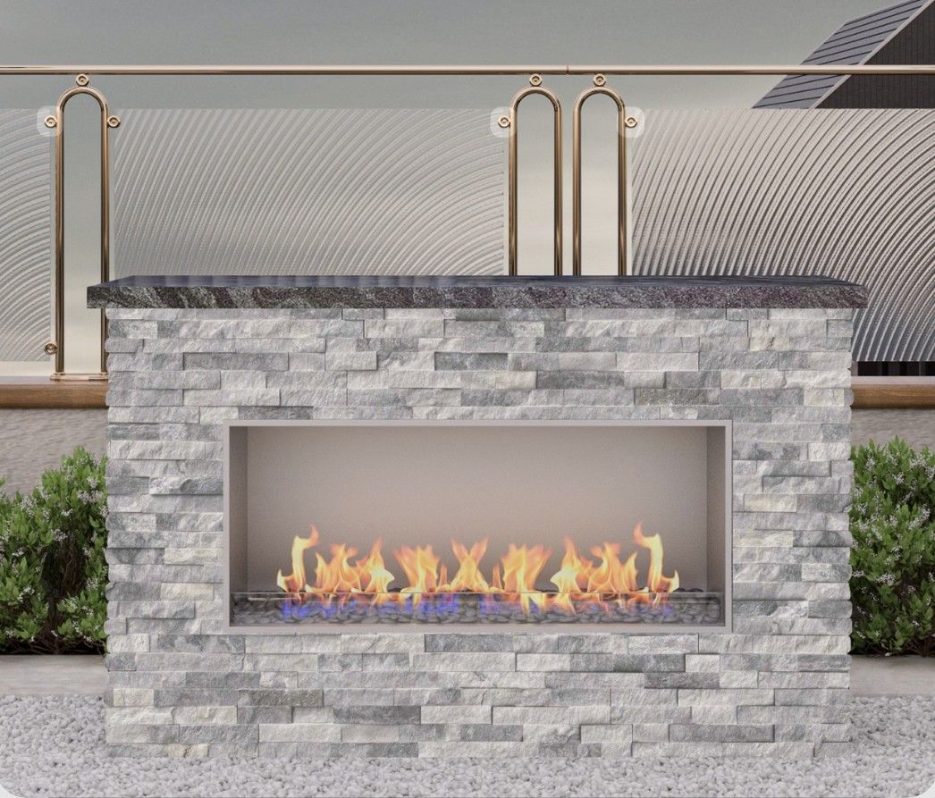 Stone outdoor fireplace with a glass front and visible flames on a patio