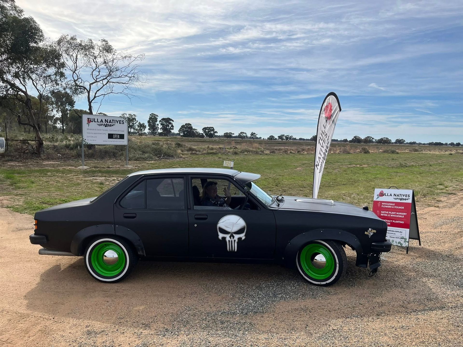 black car parked on the side of the road 
