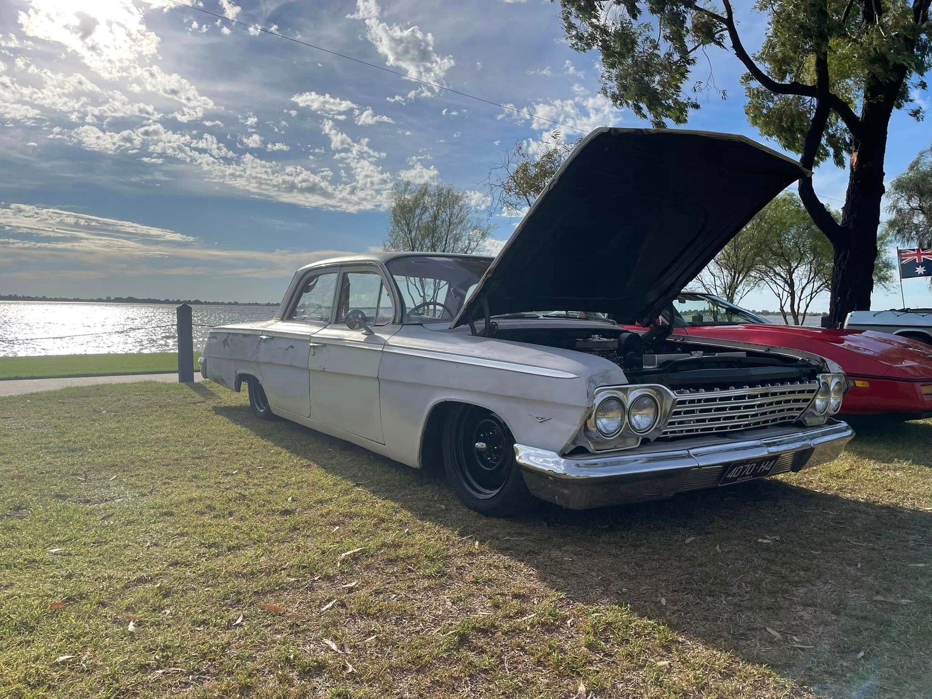 Car parked on foreshore of lake with the bonnet up 