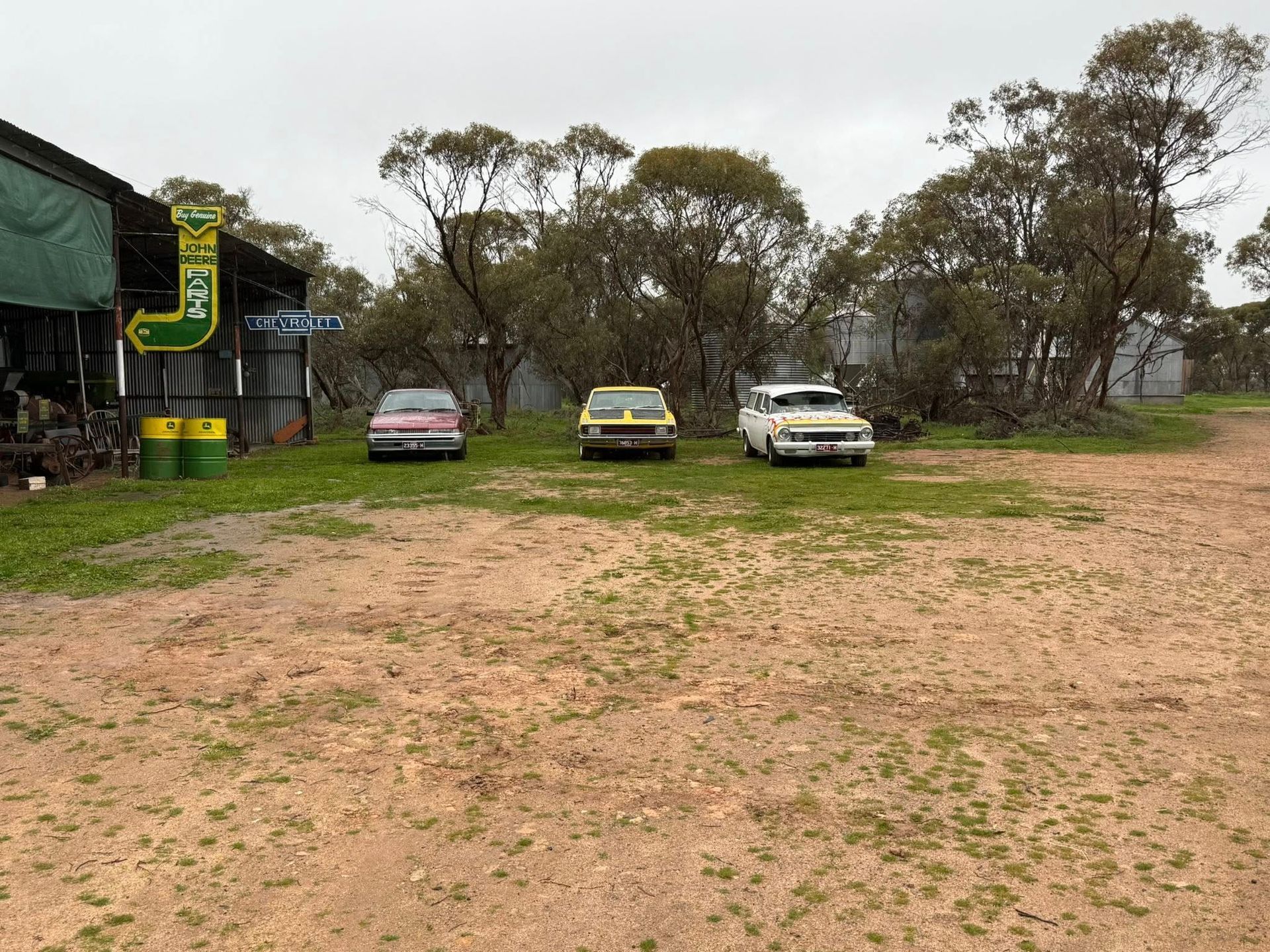 three cars on a farm