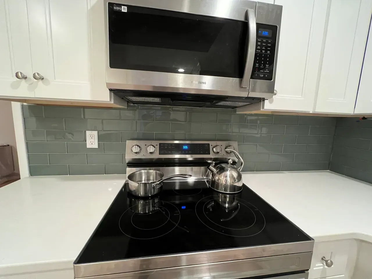 A kitchen with a stove top oven and a microwave.
