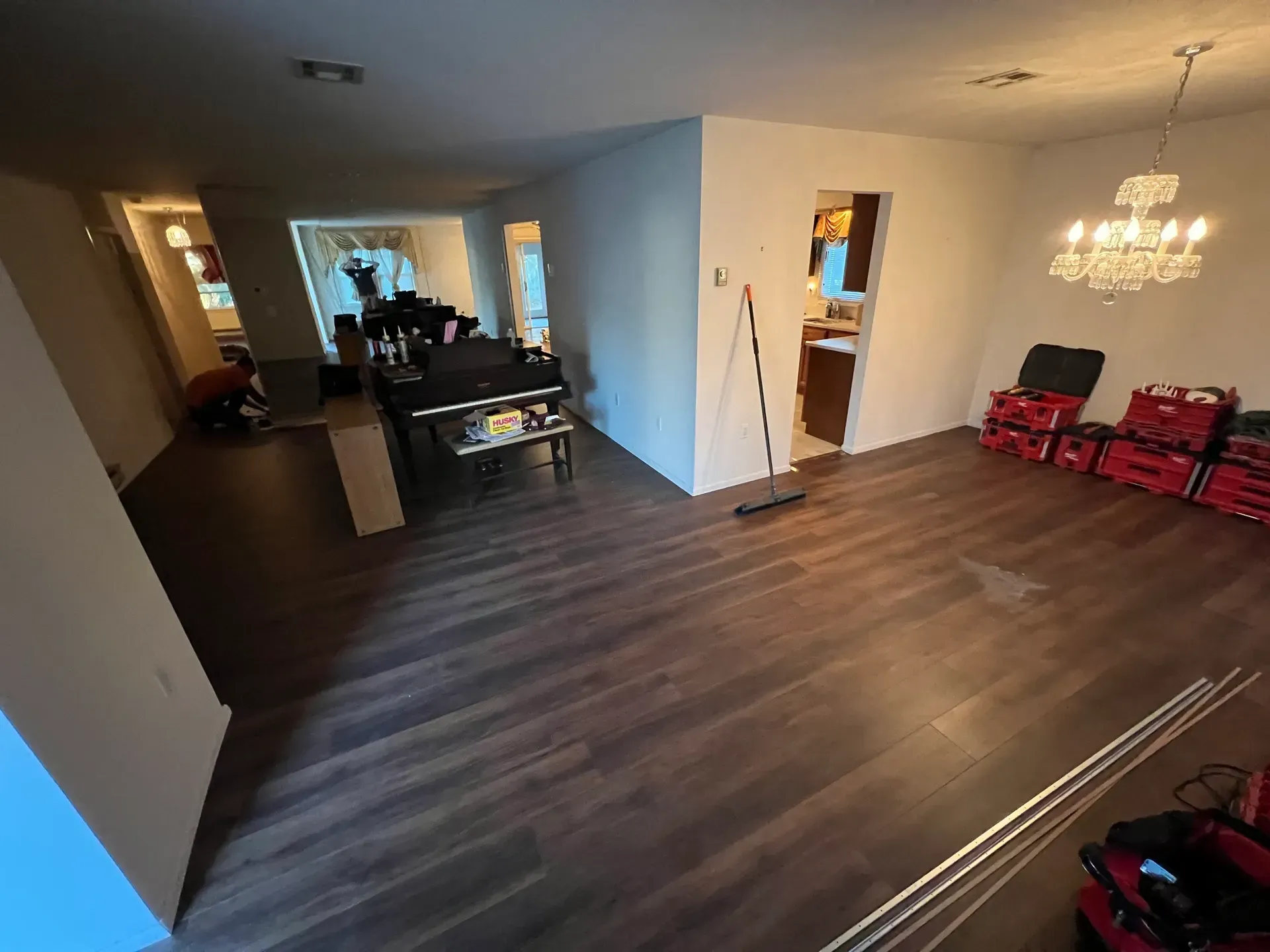 A living room with hardwood floors and a chandelier.