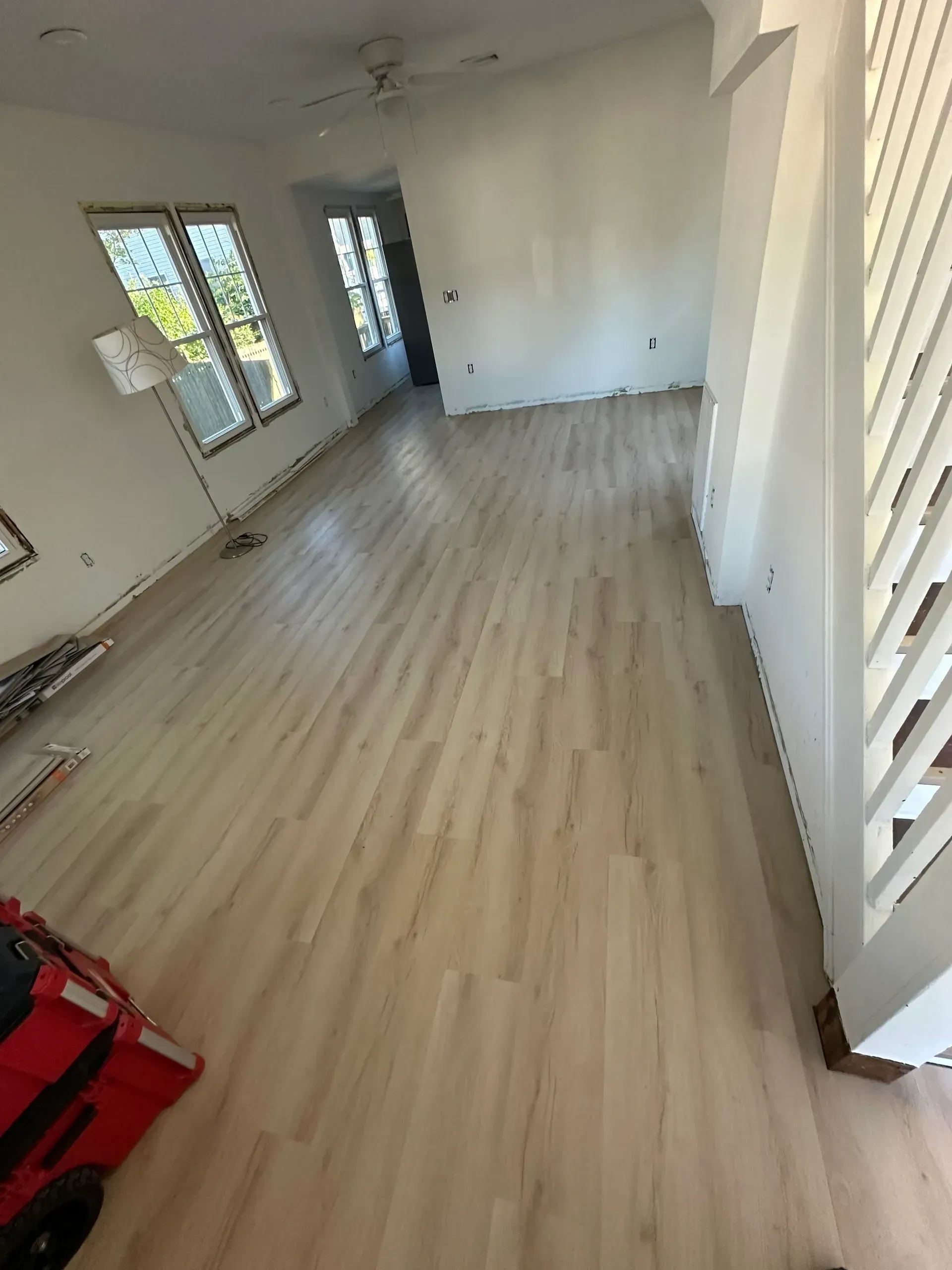 A living room with hardwood floors and white walls.