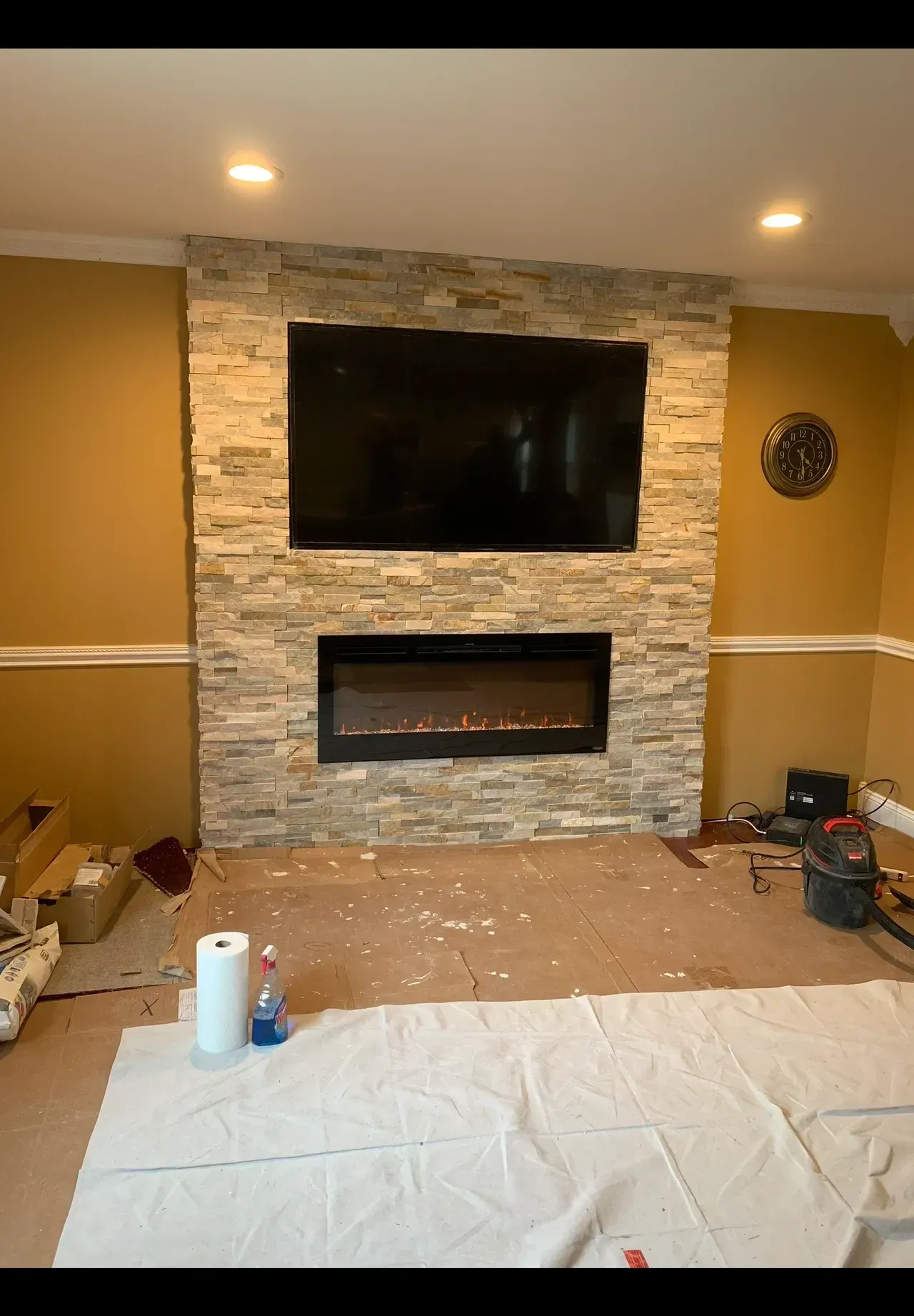 A living room with a fireplace and a flat screen tv.