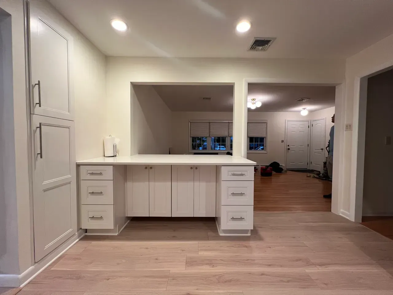A room with a desk and drawers in it