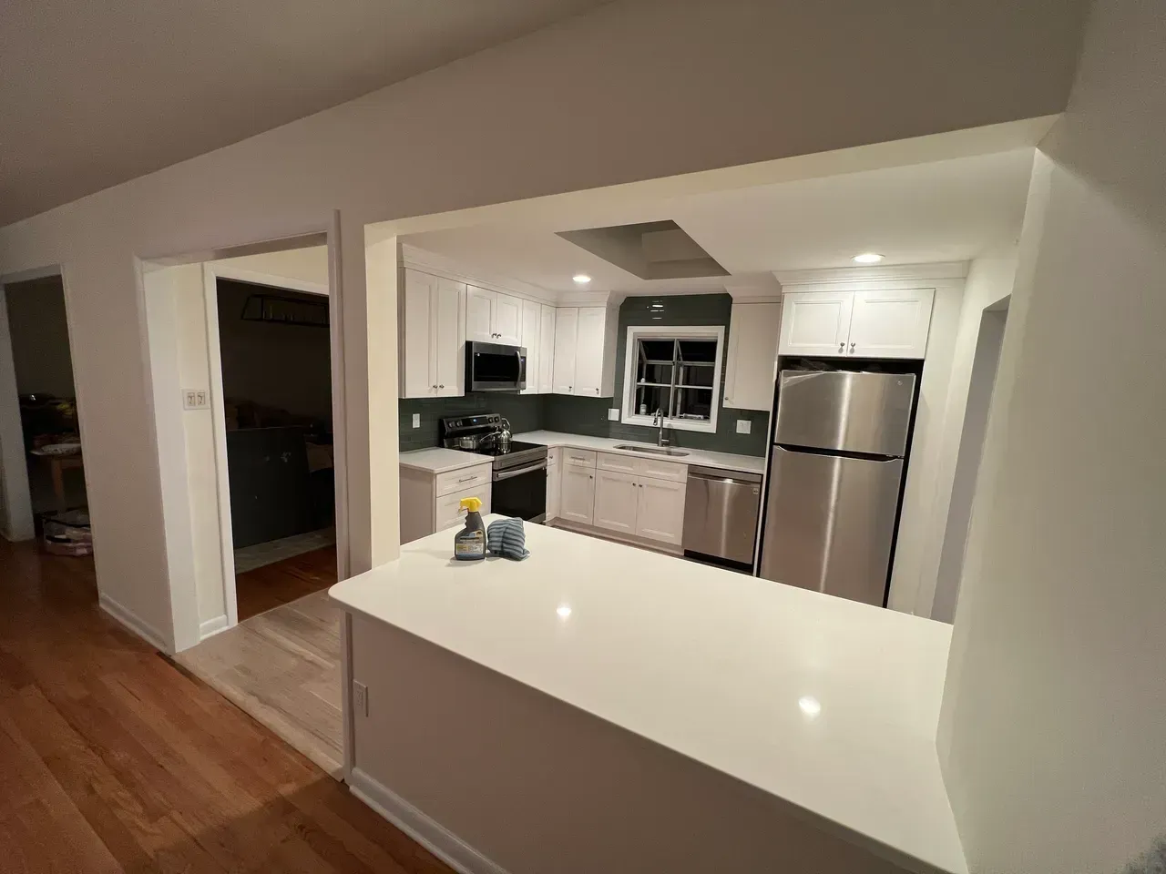 A kitchen with stainless steel appliances and white cabinets