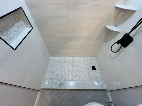 A bathroom with a walk in shower and a toilet