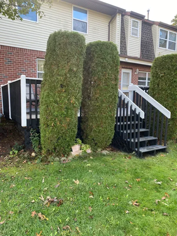 A house with a deck and stairs in front of it.