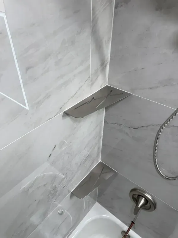 A bathroom with a bathtub and a shower head.