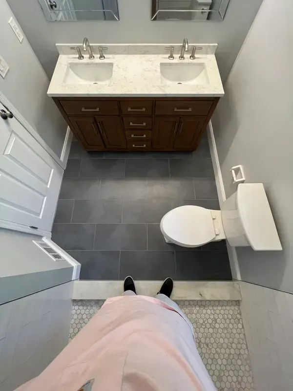 An aerial view of a bathroom with two sinks and a toilet