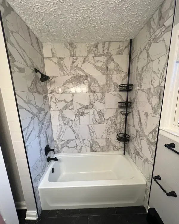 A bathroom with a bathtub and a shower.