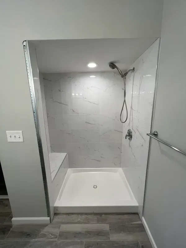A bathroom with a walk in shower and a bathtub.