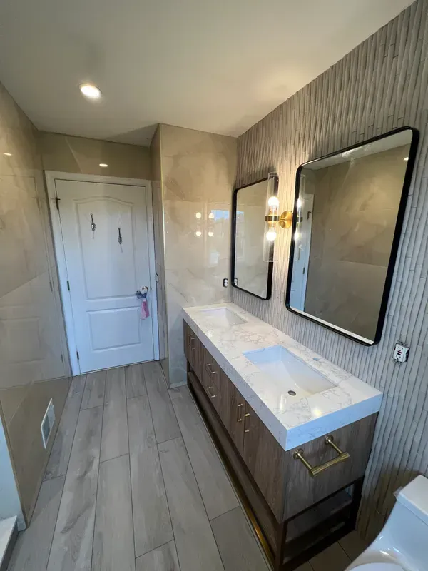 A bathroom with two sinks and two mirrors.