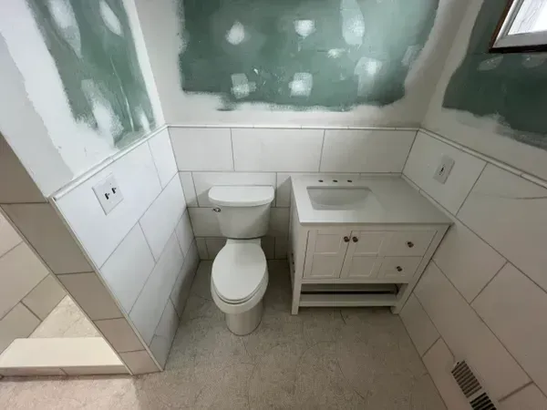 A bathroom under construction with a toilet and sink.